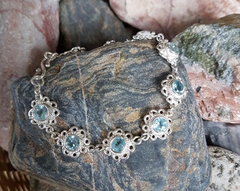 Beautiful handcrafted wirework sterling silver and light blue 6 mm faceted topaz gemstone bracelet.