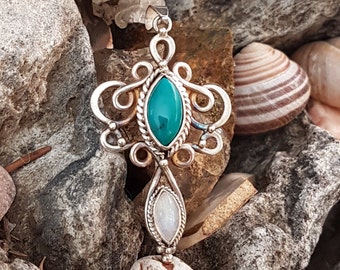 Handcrafted sterling silver filigree pendant featuring Tibetan turquoise and moonstone. 1 1/2 inches long