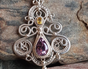 Handcrafted sterling silver filigree necklace featuring dark purple faceted teardrops and a 5x3 yellow tundra sapphire.