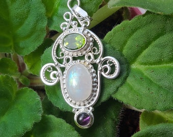 Handcrafted sterling silver filigree pendant featuring a lovely moonstone center stone and accented with peridot and amethyst