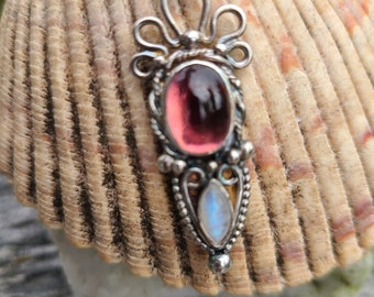 Handcrafted sterling silver pendant with a beautiful pink tourmaline cabochon and a lovely moonstone accent stone.