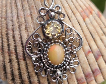 Handcrafted sterling silver filigree pendant featuring a beautiful Ethiopian opal and a faceted citrine with lots of sparkle.