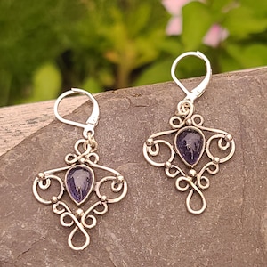Sterling silver dangle earrings with blue iolite teardrop shaped stones.  Antiqued for a vintage look.
