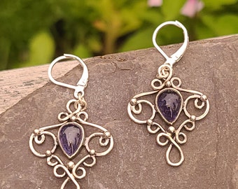 Sterling silver dangle earrings with blue iolite teardrop shaped stones.  Antiqued for a vintage look.