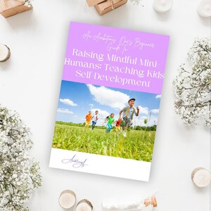 May include: A book cover titled "Raising Mindful Mini-Humans: Teaching Kids Self Development." The cover shows children running in a field under a blue sky. The book is surrounded by decorative elements, including flowers and candles.