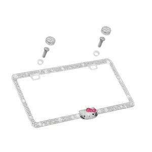 May include: A silver license plate frame encrusted with rhinestones. The frame features a Hello Kitty design with a pink bow. Includes mounting hardware.