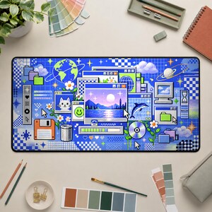 May include: A rectangular desk mat featuring a vibrant blue pixel art design. The graphic includes multiple computer windows, a globe, a dolphin, a floppy disk, a CD, a smiley face, a cat, flowers, and clouds set against a grid background.