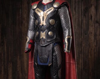 May include: A full-body costume armor set featuring a black chest plate with gold-toned accents, silver quilted sleeves, and black trousers. The ensemble includes a long, flowing red cape attached at the shoulders and matching black and gold gauntlets.