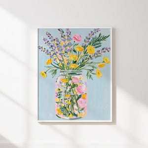 May include: A framed floral art print featuring a mason jar filled with colorful flowers. The flowers include yellow, pink, and purple blooms, set against a light blue background. The artwork is a vibrant and cheerful depiction of a floral arrangement.