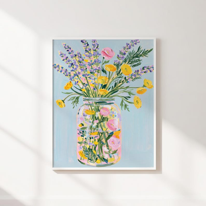 May include: A framed floral art print featuring a mason jar filled with colorful flowers. The flowers include yellow, pink, and purple blooms, set against a light blue background. The artwork is a vibrant and cheerful depiction of a floral arrangement.
