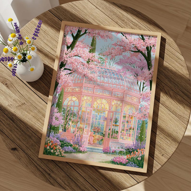 May include: A framed art print depicts a pink greenhouse surrounded by blooming cherry blossom trees. The artwork features a detailed illustration of the glass structure, with flowers and plants in the foreground. The print is set on a wooden table with a vase of flowers.