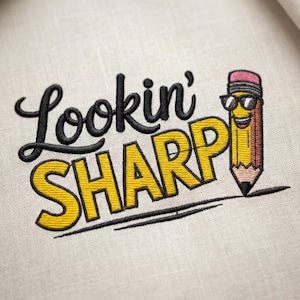 May include: Embroidered design with the words "Lookin' SHARP" in black and yellow, accompanied by a smiling pencil wearing sunglasses. The pencil is yellow, brown, and pink, with a black outline. The design is on a light beige fabric.