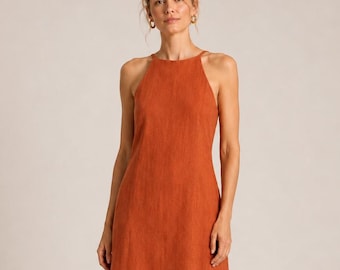 May include: A sleeveless midi dress in a solid burnt orange color. The garment features a high, straight-cut neckline with thin straps that extend to the shoulders, a fitted bodice, and a straight skirt that falls to the mid-calf length.