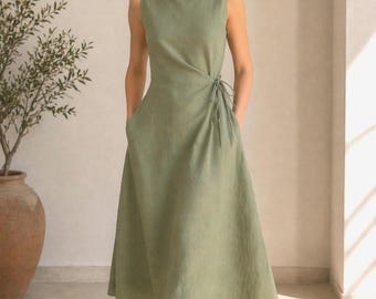 May include: A sleeveless sage green midi dress featuring a boat neckline, a fitted bodice with a side tie closure, and a flared skirt with side pockets. The dress is crafted from a textured fabric and falls to a mid-calf length, providing a clean silhouette.