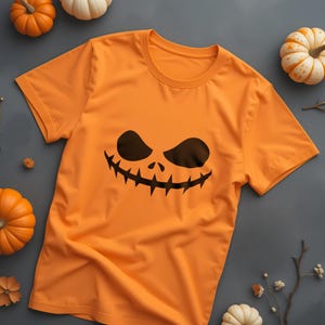 Spooky Pumpkin Smile Graphic Tee: Halloween Fun Wear