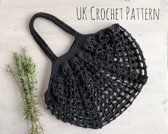 Puede incluir: Bolso de mano de crochet negro con un patrón de crochet del Reino Unido. El bolso tiene una parte superior ancha y abierta y un solo asa.