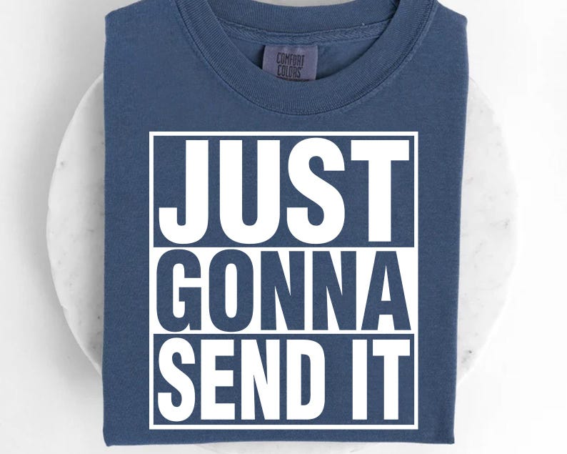 A blue t-shirt with the text "JUST GONNA SEND IT" printed on it.