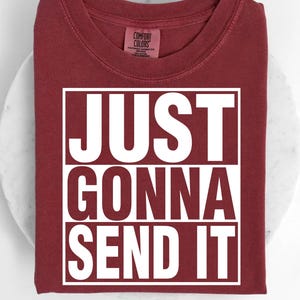A red t-shirt with the text "JUST GONNA SEND IT" printed on it.