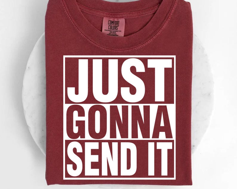 A red t-shirt with the text "JUST GONNA SEND IT" printed on it.