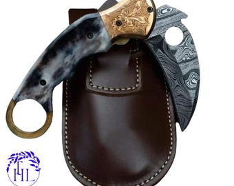 Cuchillo plegable de Damasco hecho a mano: guarda de latón grabado, mango de hueso y funda de cuero.
