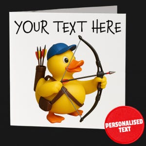 May include: A square greeting card with a yellow rubber duck wearing a blue cap and holding a bow and arrow. The card has the text "YOUR TEXT HERE" at the top and a red circle with "PERSONALISED TEXT" at the bottom.