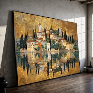 May include: A large rectangular wall art print featuring a landscape of a lakeside village with multi-colored buildings, tall cypress trees, and a golden sky filled with swirling circular patterns, all reflected in the calm water below.