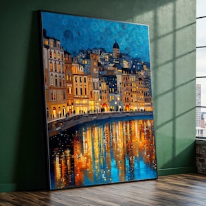May include: A framed art print depicting a European cityscape at night. The buildings are illuminated with warm light, reflecting in the water below. The sky is a deep blue with textured brushstrokes, creating a vibrant and detailed artwork.