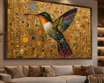 May include: Large framed artwork featuring a vibrant hummingbird with outstretched wings. The bird has green, blue, and orange plumage against a gold background with circular and geometric patterns. The artwork is displayed above a beige sofa.