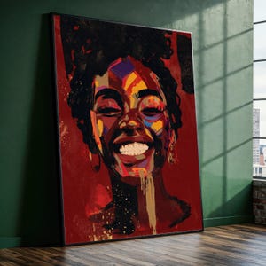 May include: A framed art print featuring a vibrant portrait of a smiling person with dark skin. The artwork uses a palette of red, yellow, blue, and gold. The person's hair is dark and curly, and they are wearing gold hoop earrings.