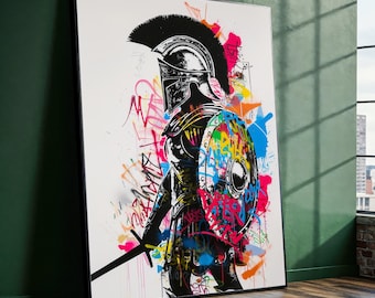 May include: Framed artwork featuring a black and white illustration of a Spartan warrior in full armor, holding a sword. The warrior and shield are covered in colorful graffiti-style paint splatters and tags, creating a striking contrast.