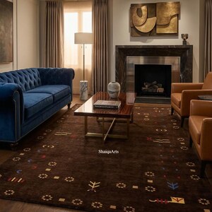 May include: A living room featuring a tufted blue velvet sofa, two brown leather armchairs, and a dark brown rug with a geometric pattern. A marble-based lamp and a dark wood coffee table are also present. A fireplace and artwork complete the scene.