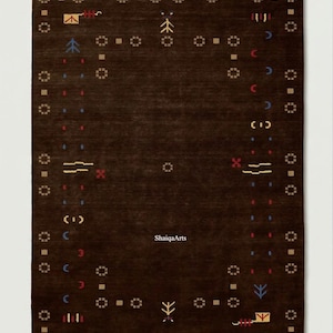 May include: A dark brown rectangular rug with a repeating geometric pattern in tan, red, blue, and yellow. The rug features a central design and a border with small square and circular motifs. The text "ShaigaArts" is visible.