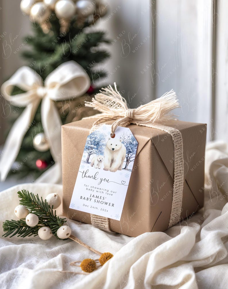 May include: A wrapped gift box with a tag featuring a polar bear and cub in a winter scene. The tag reads "thank you" and "JAMES BABY SHOWER Dec 24th, 202x". The box is wrapped in brown paper and tied with twine.