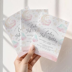 May include: Three baby shower invitations with a watercolor design. The invitations feature a crescent moon, stars, and clouds in pastel colors. The text reads "Join us to celebrate Emilia's First Birthday".