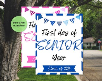 May include: Two signs with the text "First day of SENIOR Year Class of 2026". One sign is blue and white, the other is pink and white. Both signs have banner decorations at the top. A green circle says "Blue & Pink In A Bundle!"