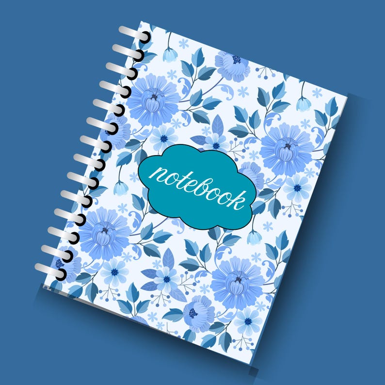 May include: A spiral-bound notebook with a floral design. The cover features a pattern of blue flowers and leaves on a white background. A teal cloud-shaped label on the cover reads "notebook" in white script. The background is a solid blue.
