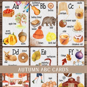 May include: Set of autumn-themed ABC flashcards. Each card features a letter and related illustrations, including apples, a bear, a campfire, a deer, and a fig. The cards are designed with watercolor-style artwork.