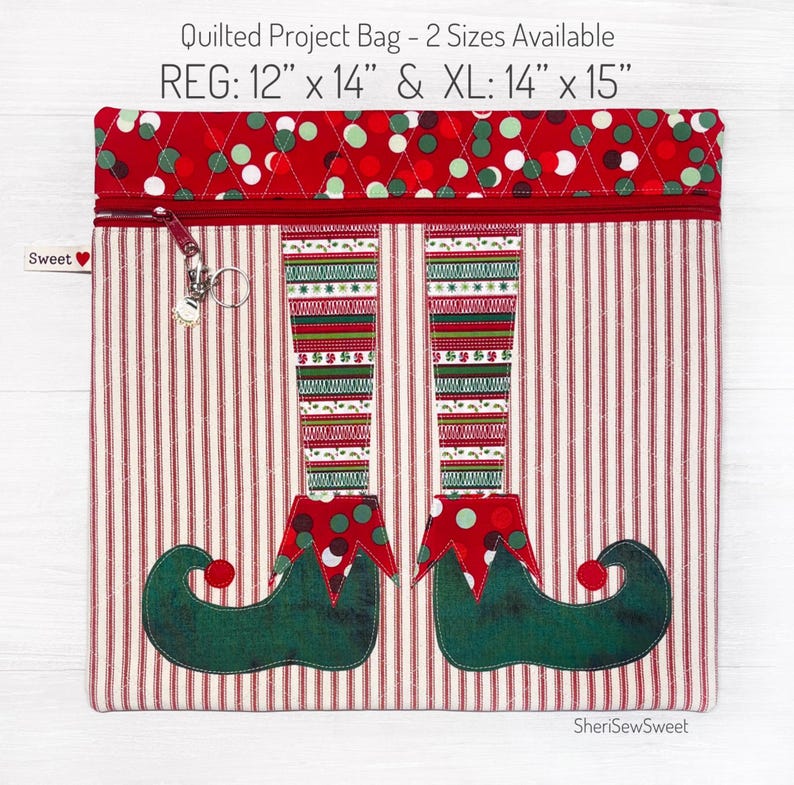 May include: Quilted project bag with a red and white striped fabric and an elf design. The bag has a zipper closure and comes in two sizes: 12" x 14" and 14" x 15".