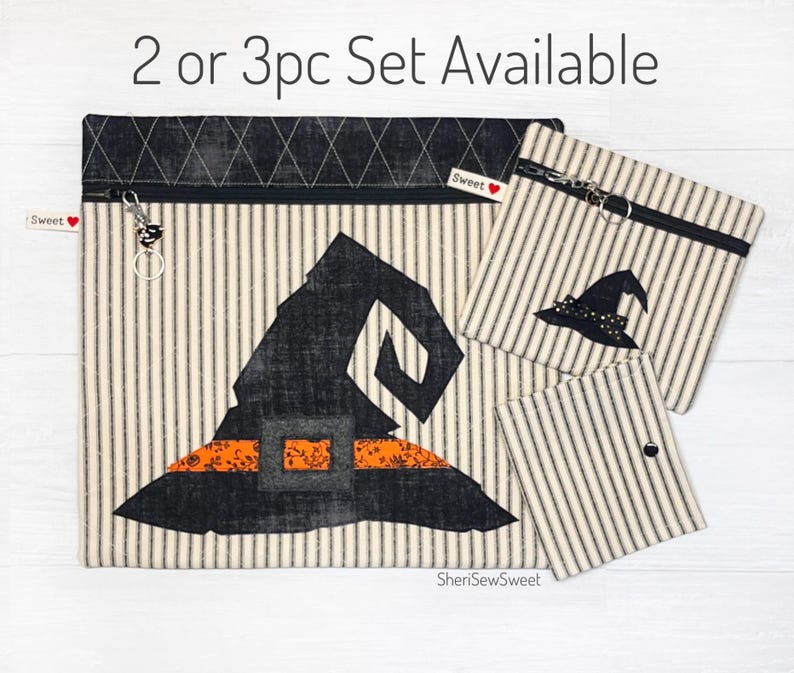 May include: A set of three witch hat-themed zippered pouches in black, white, and orange. The largest pouch features a large witch hat with a black brim and orange trim. The smaller pouches feature a smaller witch hat design. The pouches are made of a striped fabric with a white background and black stripes. The text "2 or 3pc Set Available" is printed at the top of the image.
