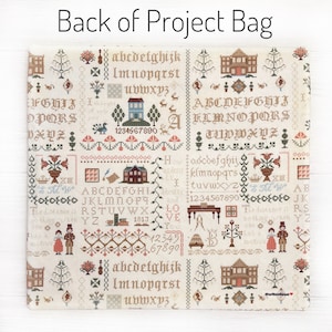 May include: A beige project bag with a detailed cross-stitch design. The bag features various motifs, including houses, trees, and floral patterns, along with the text "Back of Project Bag". The design includes letters and numbers.