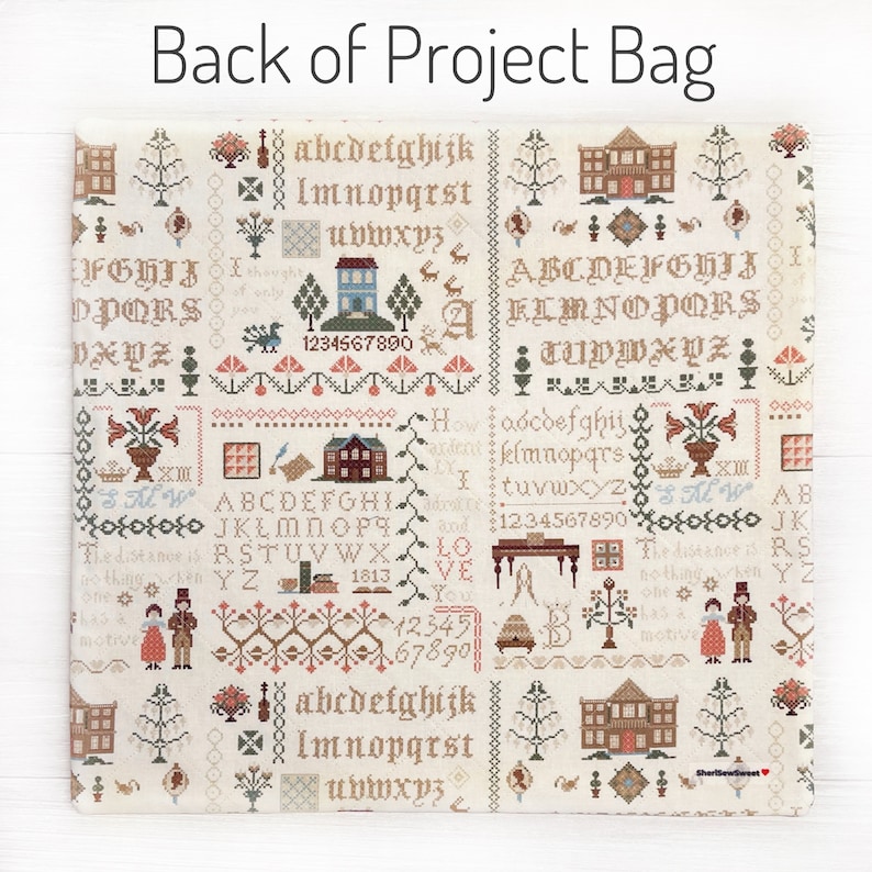 May include: A beige project bag with a detailed cross-stitch design. The bag features various motifs, including houses, trees, and floral patterns, along with the text "Back of Project Bag". The design includes letters and numbers.