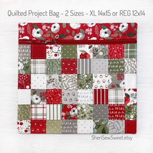 May include: Quilted project bag with a patchwork design in red, green, and gray. The bag features a zipper closure and is available in two sizes: XL 14x15 inches or REG 12x14 inches. The bag is decorated with floral and holiday-themed patterns.