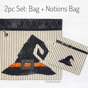May include: A 2-piece set of Halloween-themed zippered bags. The larger bag features a black witch hat with an orange and black striped band. The smaller bag features a smaller black witch hat. Both bags are made of a white fabric with black stripes.