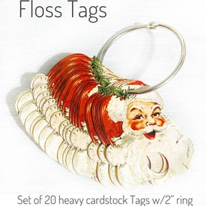 May include: A set of 20 heavy cardstock floss tags with a 2-inch ring. The tags feature a vintage Santa Claus design with red and white colors. The text "Floss Tags" is at the top.