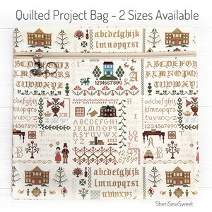 May include: Quilted project bag with a cream background, featuring cross-stitch style patterns of houses, trees, and alphabets. The bag has a beige zipper and the text "Quilted Project Bag - 2 Sizes Available".