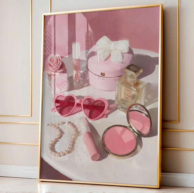 May include: A framed artwork featuring a collection of pink accessories. Heart-shaped sunglasses, a pearl necklace, a compact mirror, and a perfume bottle are arranged on a white surface. A pink box with a white bow and a rose are also visible.