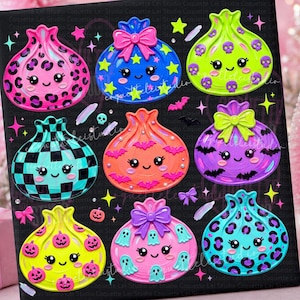 May include: A black surface featuring eight colorful, rounded, cartoon-style characters with smiling faces. Designs include leopard print, checkered patterns, bows, skulls, bats, ghosts, and pumpkins in vibrant shades of pink, blue, green, and orange.