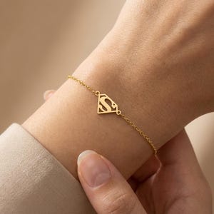 May include: A set of three ceramic mugs with a speckled, matte finish. The mugs are in shades of cream, light gray, and dark gray. Each mug has a simple, minimalist design, perfect for coffee or tea.