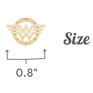 May include: A wooden Wonder Woman logo, 0.8 inches in diameter, with a circular frame, wings, and stars. The word "Size" is written in a script font.