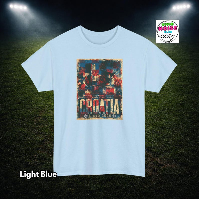 Light blue Croatia football tee with faded red white and blue colours, distressed retro football lettering and summer 2026 tournament energy.